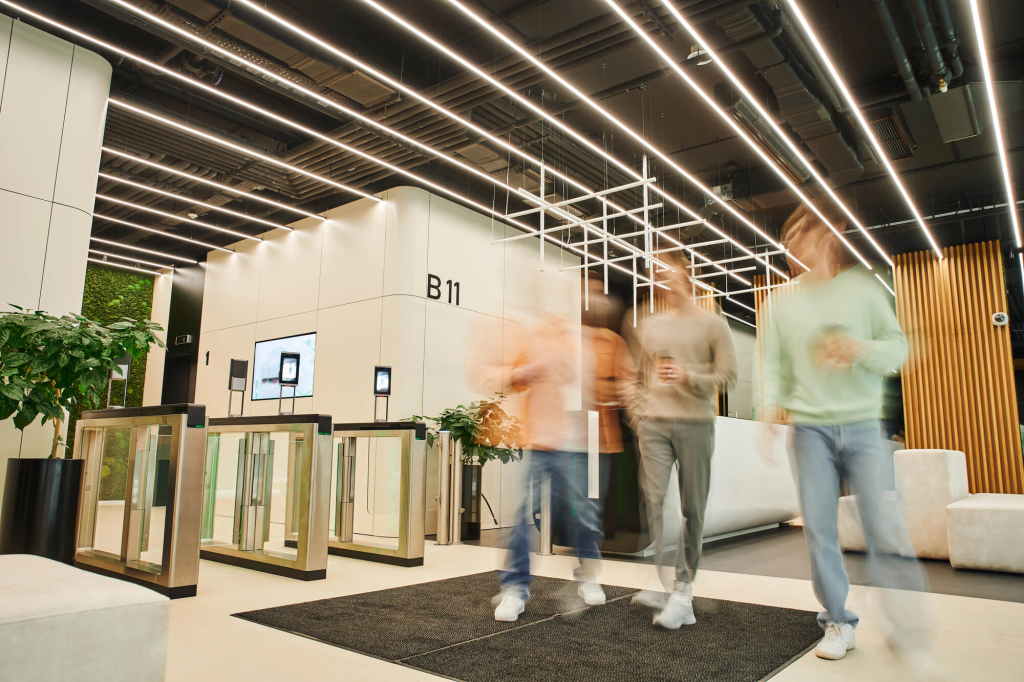 Welcoming office entryway with sleek design, natural light, and greenery, creating a professional and collaborative environment.